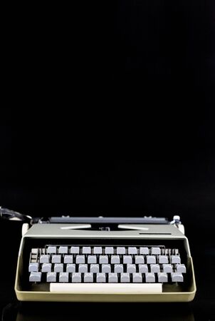Typewriter on the table on a black background. Workplace of the writer or author. bloger Idea Concept.の写真素材