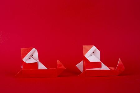 New Year card handmade origami Santa Claus on a sleigh. Christmas concept winter crafted decorations studio shotの写真素材