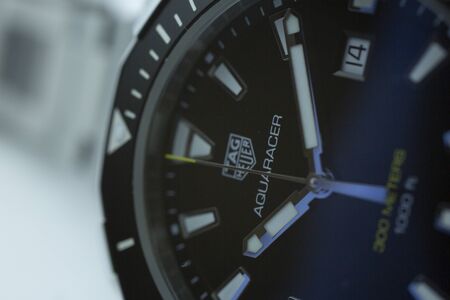 Chaux-de-Fonds, Switzerland, August 21 2019 - The close up of Tag Heuer Aquaracer steel black mecanical watch, a famous swiss made luxury wrist watch from Switzerland manufacturing clock companyのeditorial素材