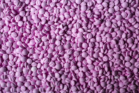 pink pills lie table background. Drugs, painkillers, colds and other medicines.の写真素材