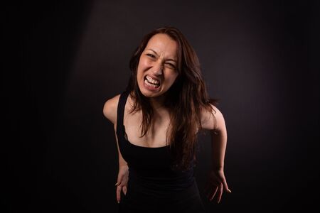 Annoyed aggressive girl screams clenching teeth. Negative human emotionsの写真素材