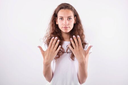 Young girl showing reverse side of palms. Isolated on white backgroundの写真素材