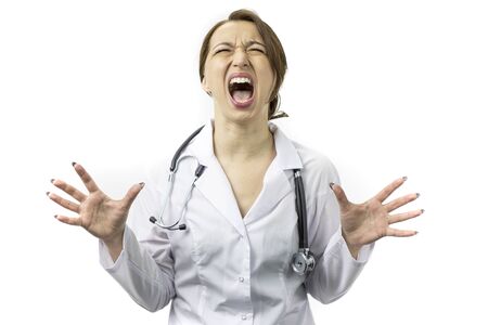 Female doctor crazy shouting and yelling with aggressive expression, arms raisedの写真素材