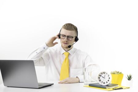 Online consultant in formal clothes with headset at desk in call center officeの写真素材