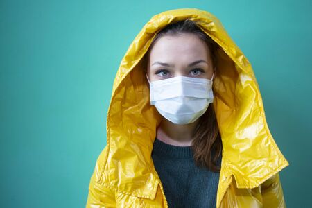 beautiful girl in medical mask in an isolated abandoned building quarantinedの写真素材