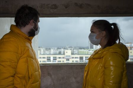 European man and woman infected with sars-cov-2 virus in protective medical maskの写真素材