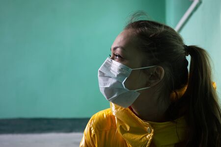 European girl infected with covid-2019 virus in a protective medical maskの写真素材