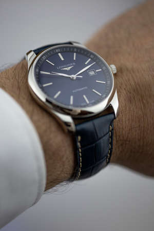 Saint-Imier, Switzerland 31.03.2020 - Closeup fashion image of Longines watch on wrist of man Longines man watch stainless steel case black clock face dial leather strap swiss quartz watch swiss made manufactureのeditorial素材