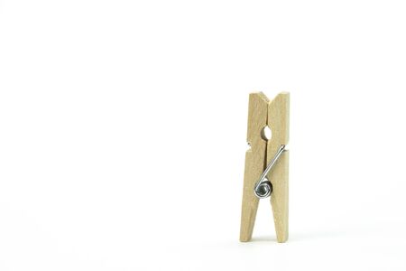 wooden clothespin, standing alone on white background. concept of lonelinessの写真素材