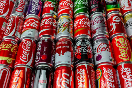 Atlanta, Georgia, USA April 4, 2020: Coca Cola background of many multicolored aluminum cans of different colors . Globalism, global brand concept worldwide distribution favorite taste concept.のeditorial素材