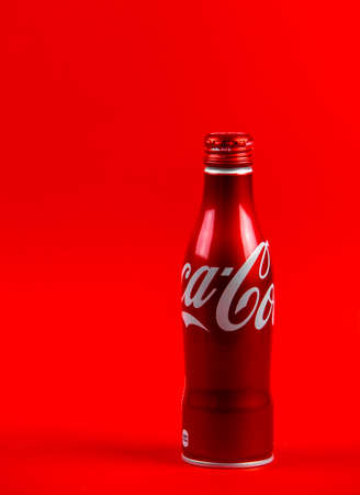 Atlanta, Georgia, USA April 1, 2020: red aluminum contour bottle of coca-cola isolated on red...