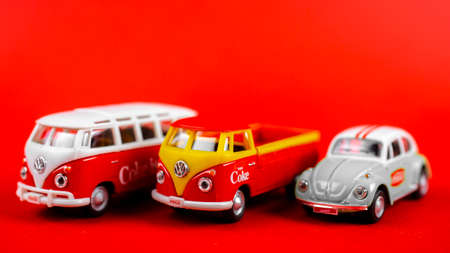 Atlanta, Georgia, USA April 1, 2020: Vintage die cast toy Transporter T1 with Coca-Cola ad 1960âs and beetle isolated on red backgroundのeditorial素材