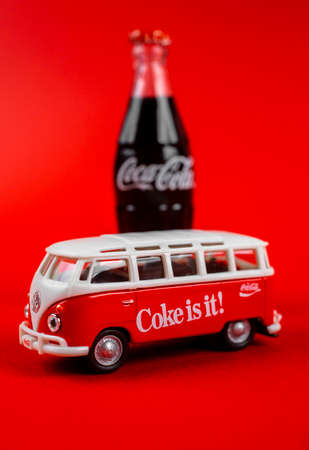 Atlanta, Georgia, USA April 1, 2020: Vintage die cast toy Transporter T1 with Coca-Cola ad 1960âs and Coca Cola contour toy bottle isolated on red backgroundのeditorial素材