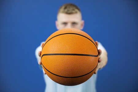 Portrait of professional young student basketball player holding basketball