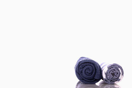 Kitchen towels for drying dishes isolated on white background. Classic blue waffle tea towel set rolled into tubes. Kitchenware, cooking workshop, kitchen cleaning life hacks concept. Copy spaceの写真素材