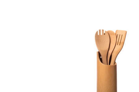 wooden bamboo kitchen utensils. Three pieces in stand. kitchen spoon and spatulas isolated on white background copy space. Home cooking concept.の写真素材