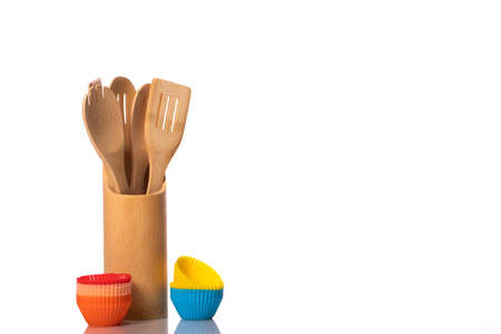 Kitchen utensils set isolated on white background. Wooden spoons, spatulas in holder and silicone...