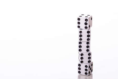end to end Stack of five white dice black pips showing six isolated on white background copy space
