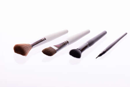 Makeup vegan brush set laying on isolated white background. Foundation, eyeshadow, blush and...