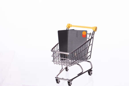 New York, USA - August 25, 2020: Two credit cards Mastercard platinum in shopping cart isolated on white background. Company providing services of payment operations for e-commerce, online shoppingのeditorial素材