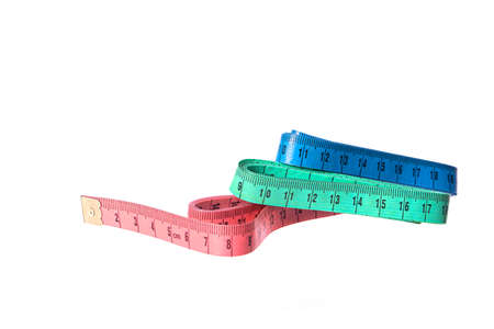 Three colored measuring tapes isolated on white background. Sewing, clothing repair, fitting,...