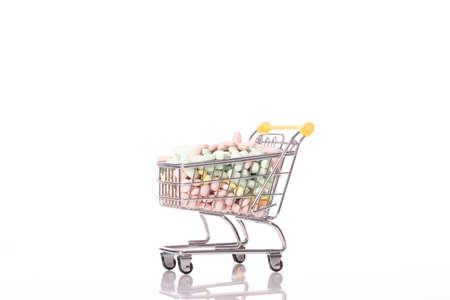 Shopping trolley filled with medicines pills isolated on white background. Healthcare, pharmacy,...
