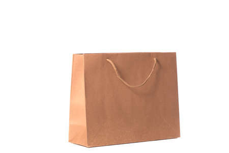 Craft reusable paper bag isolated on white background. Eco-friendly shopping bag, brown carrier bag with handles, recycled paper package, delivery service, environmental protection concept. Copy spaceの写真素材