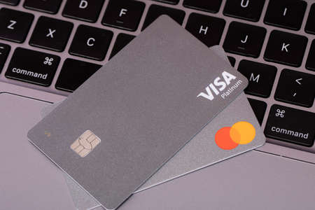 Foster City, California, USA - Sep 1, 2020: platinum cards Visa and MasterCard lying on silver...