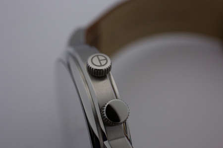 Geneve, Switzerland 01.10.2020 - Claude Bernard wiss made watch close up detail Clock crown. Swiss watchmaker, watch manufactory brand. High quality stainless steelのeditorial素材