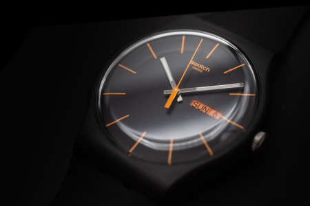 London, GB 07.10.2020 - Swatch cheapest swiss made quartz watch close up isolated on black...