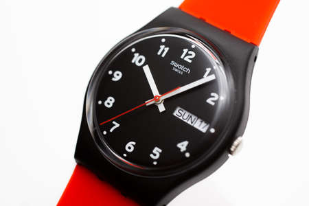 London, GB 07.10.2020 - Swatch swiss made quartz watch isolated on white background. day and date...
