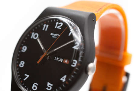 New York, NY, USA 07.10.2020 - Swatch logo on black wristwatch dial of swiss made quartz watch...