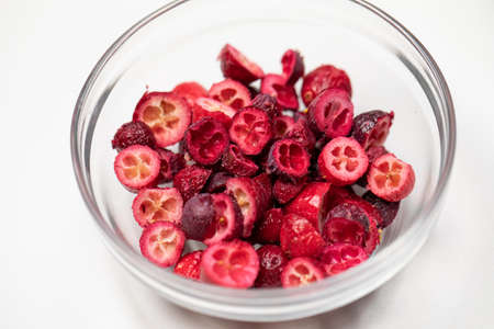 Freeze-dried organic cranberry berries in glass bowl for cakes, pastry, handmade chocolates. Filling...