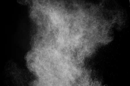 Flying white powder on isolated black background, dust debris. Creative hurricane storm tornado...