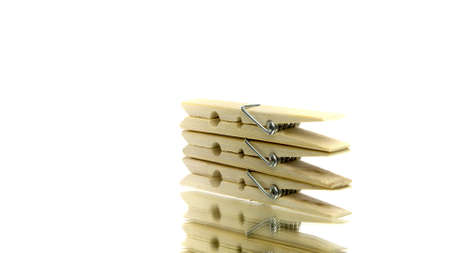 Wooden clothespin for drying clothes rotating on isolated white background. Clothes pin peg in...