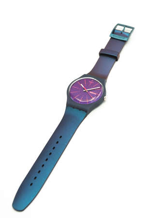 Rome, Italy 07.10.2020 - Swatch fashion swiss made quartz watch close up on stand. blue plastic case and pearlescent strap, Fluorescent colors youth hipster style watchのeditorial素材
