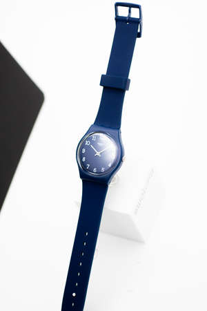 Rome, Italy 07.10.2020 - Swatch fashion swiss made quartz watch close up. blue case and strap stylish trendy womens accessory. young businesswoman fashion detail. Swatch Group watch productionのeditorial素材