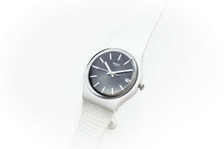 Paris, France 07.10.2020 - Swatch cheapest trendy swiss made quartz watch on brand showcase stand. white plastic case youth hipster style watch for bright image. Swatch Groupのeditorial素材