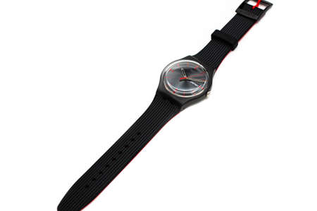 Geneve, Switzerland 07.10.2020 - Swatch cheapest trendy swiss made plastic watch, simple black design, Red seconds arrow, Sunday 15 on calender. Value Price concept.のeditorial素材