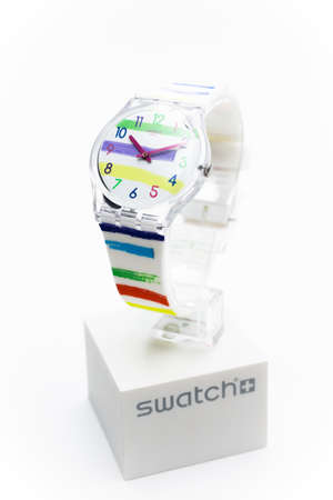 Rome, Italy 07.10.2020 - Swatch trendy fashion swiss made quartz watch isolated on brand stand close up. transparent plastic case striped design, youth hipster style watch for bright image.のeditorial素材