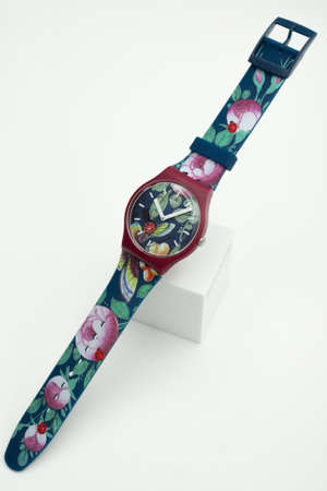 London, GB 07.10.2020 - Swatch trendy swiss made quartz watch isolated on white background. colored plastic case, natural elements print ladybug, butterflies, dragonflies, hipster style watchのeditorial素材