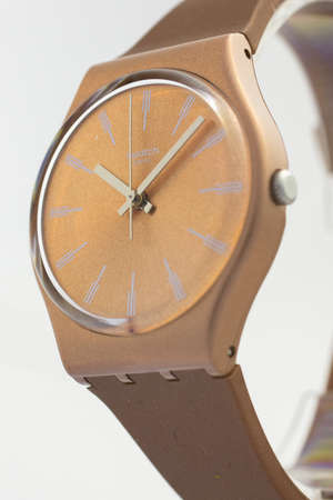 Rome, Italy 07.10.2020 - Swatch fashion swiss made quartz watch on stand close up. beige case stylish trendy womens accessory. young businesswoman fashion detail. Swatch Group watch productionのeditorial素材