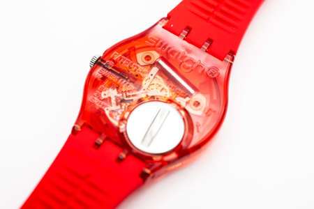 Paris, France 07.10.2020 - Swatch trendy swiss made quartz red color watch back case battery...