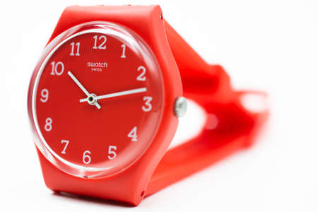 Rome, Italy 07.10.2020 - Swatch fashion swiss made quartz watch isolated on white selected focus close up. red plastic case. Swatch Group watch productionのeditorial素材