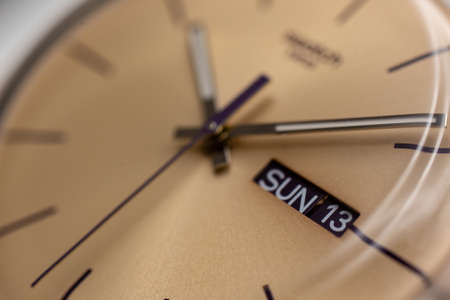 Geneve, Switzerland 07.10.2020 - Swatch watch. beige wristwatch dial, Sunday 13 on calender close...