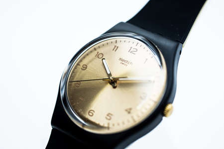 Geneve, Switzerland 07.10.2020 - Swatch swiss on beige wristwatch dial of swiss made mechanical watch close up. Time is ticking concept. Swatch Group watch productionのeditorial素材