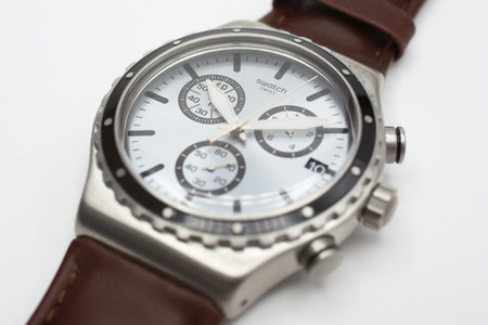 Rome, Italy 07.10.2020 - Swatch classic design swiss made mechanical watch isolated on white background. metal case date 10, stylish mens accessory. Swatch Group watch productionのeditorial素材