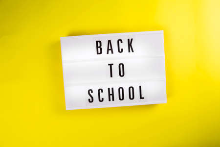 Back to school message on lightbox on yellow background isolated. Unschooling, Home Learning, Home school, Homeschooling, Home Education, studying home, learning method conceptの写真素材