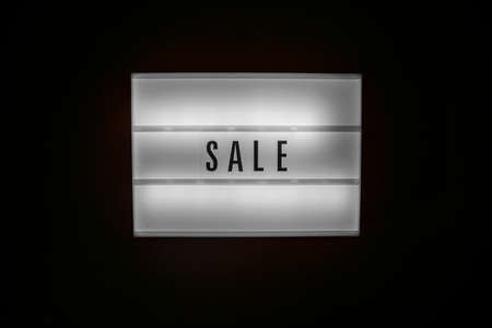 Sale word on Illuminated lightbox in dark. Concept Black friday, season sales time. Sales, special...