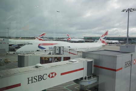 London, Heathrow, UK 2.09.2019 - British Airways Boeing 747-400 airplanes docked in Heathrow airport (LHR) Preparation for departure, tail livery on planes. HSBC advertising on boarding bridgeのeditorial素材